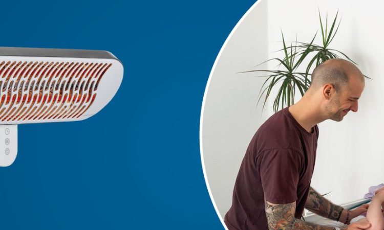 Vater beim Wickeln von Baby unter Wickeltisch-Wärmestrahler.